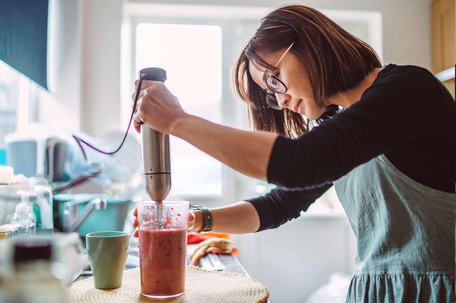 woman using immersion blender