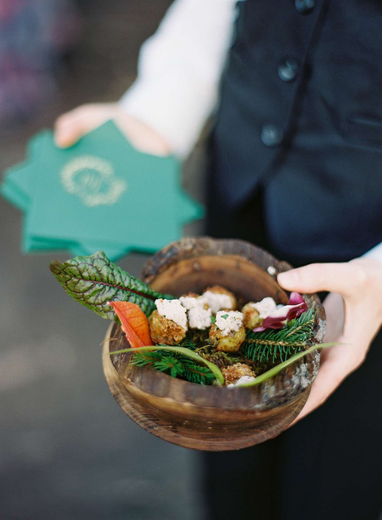 cocktail hour food in wooden bowl with foliage