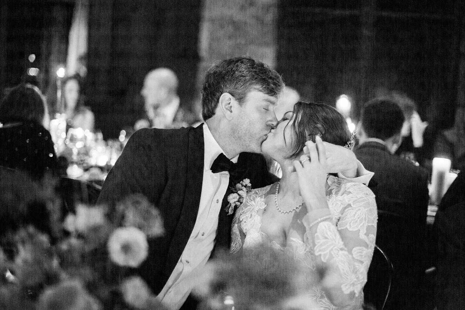 bride and groom kiss seated during reception