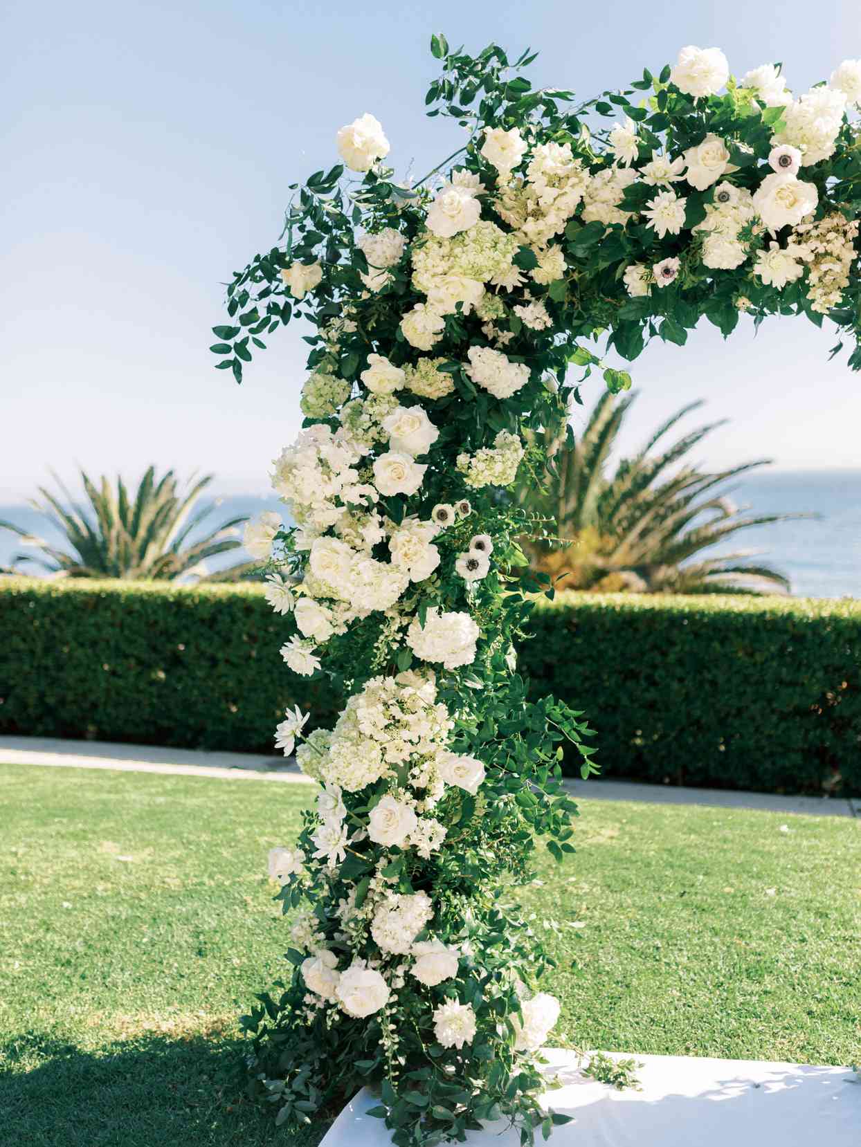 all white floral wedding arch for the ceremony