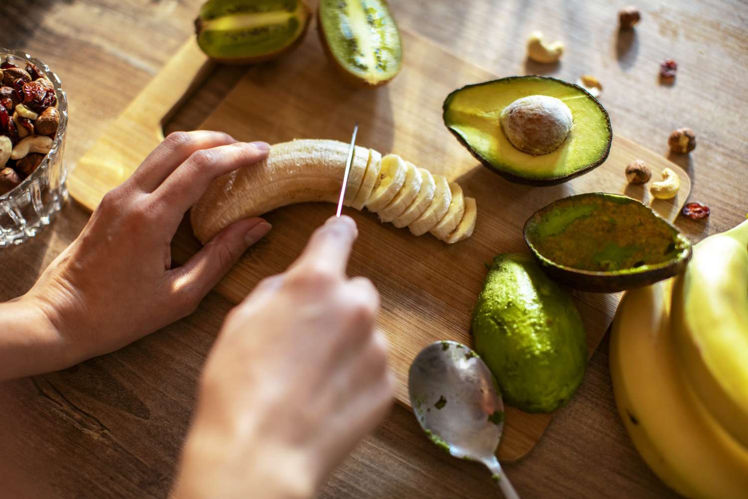 woman slicing banana and avocado