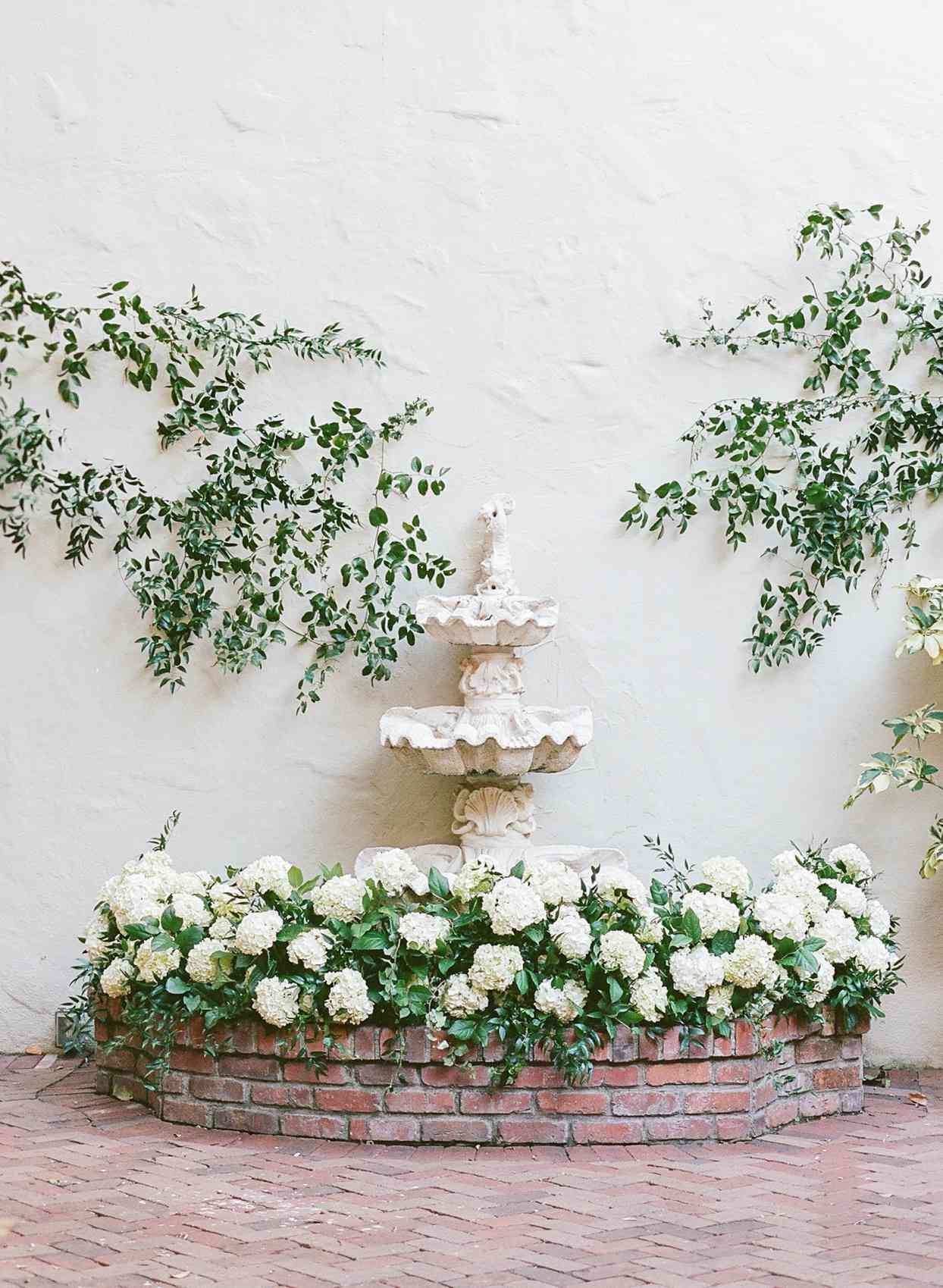 outdoor ceremony altar at fountain with white flowers