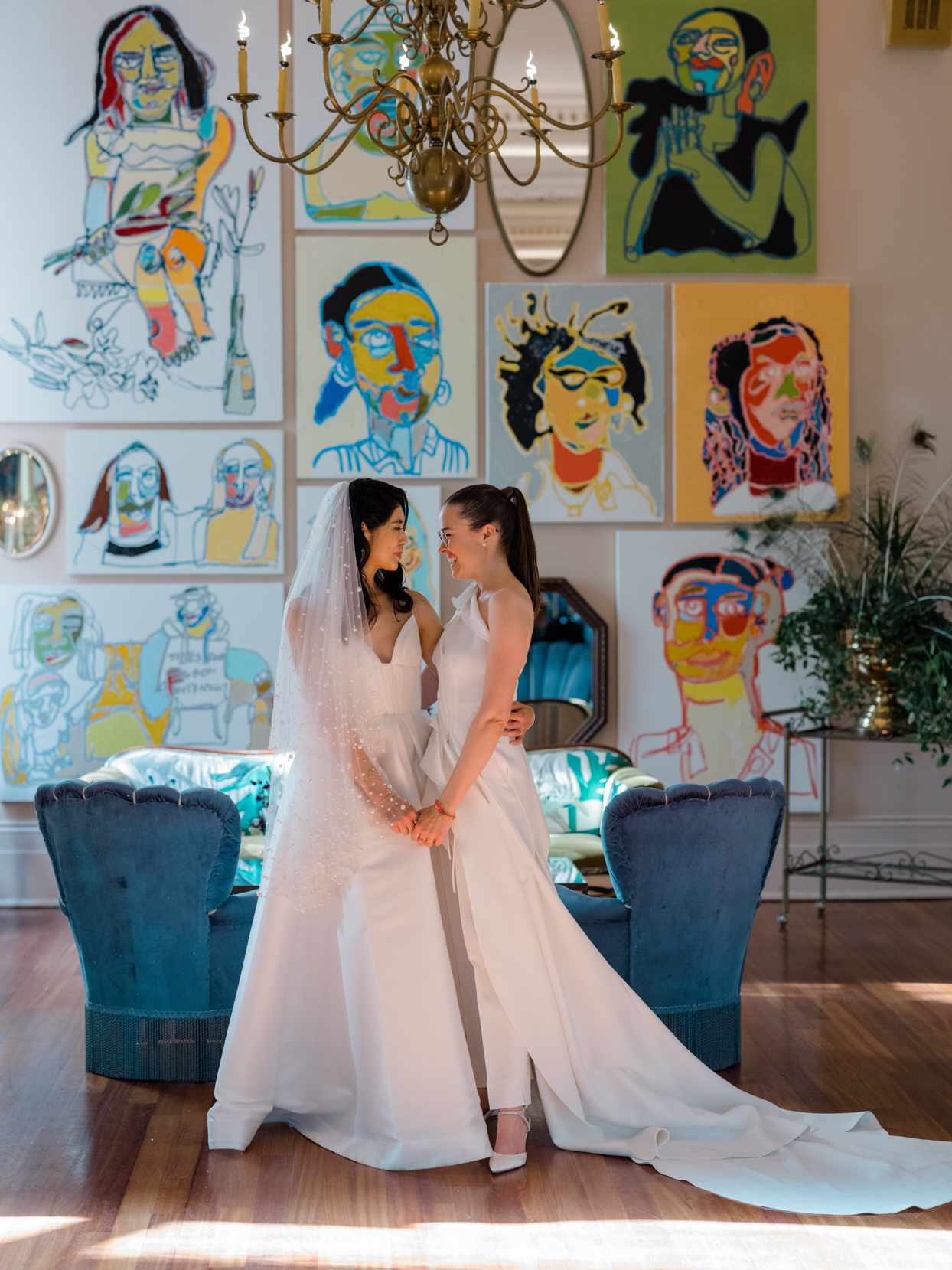 brides in wedding venue with colorful wall art paintings