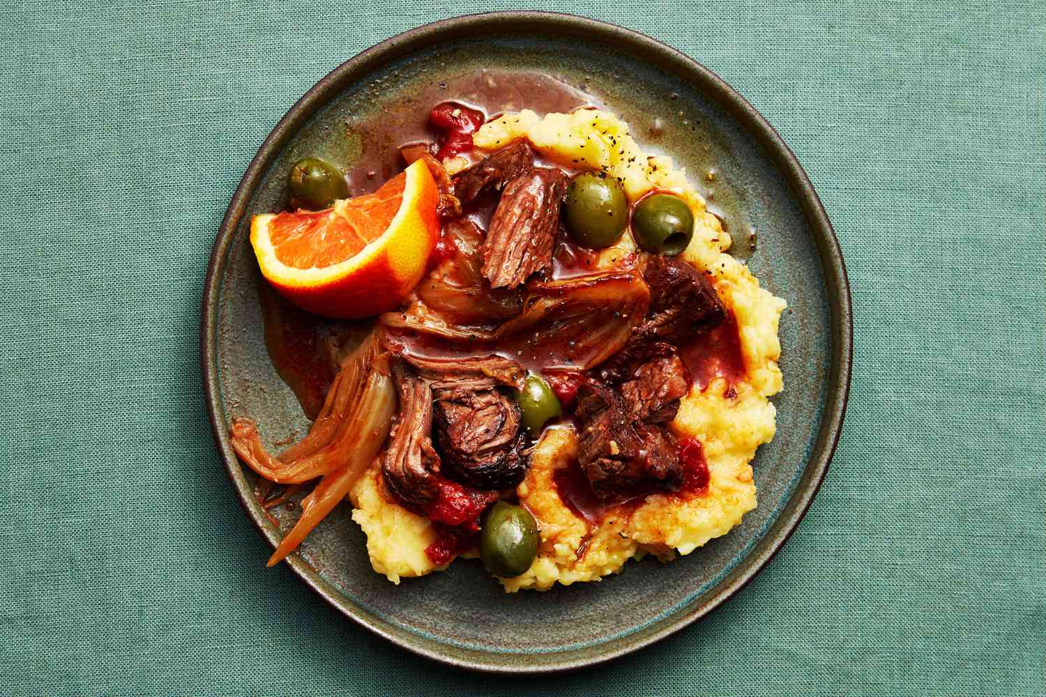 Beef stew with olives and mashed potatoes