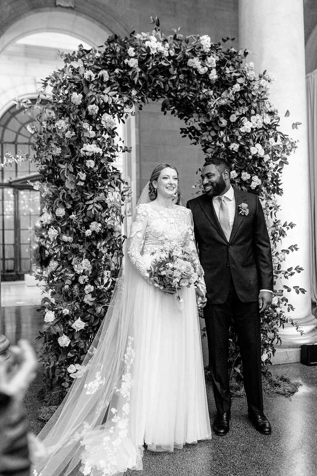 bride and groom indoor ceremony floral arch