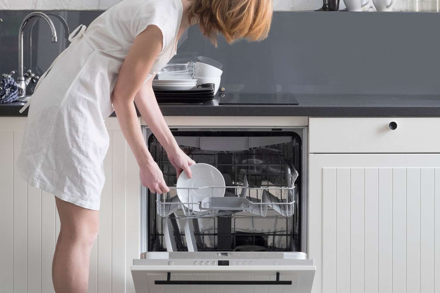 Woman loading the dishwasher
