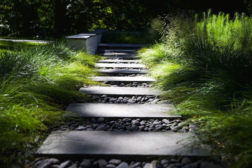 Hardscaping outside grass path with rocks and concrete