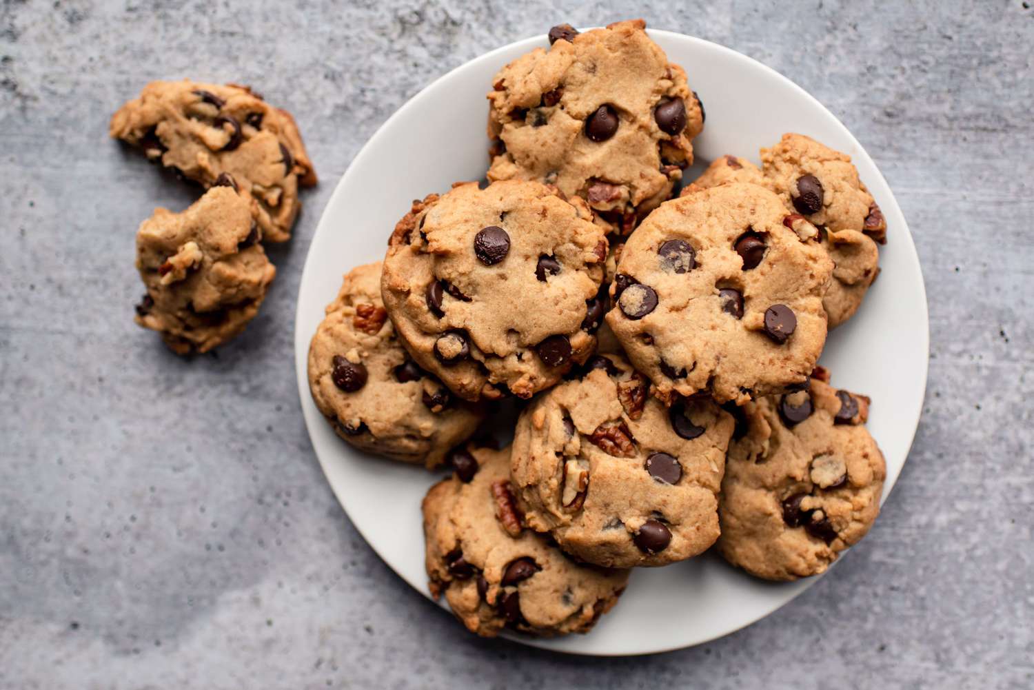 Close up of freshly baked chocolate chip cookies on plate from above