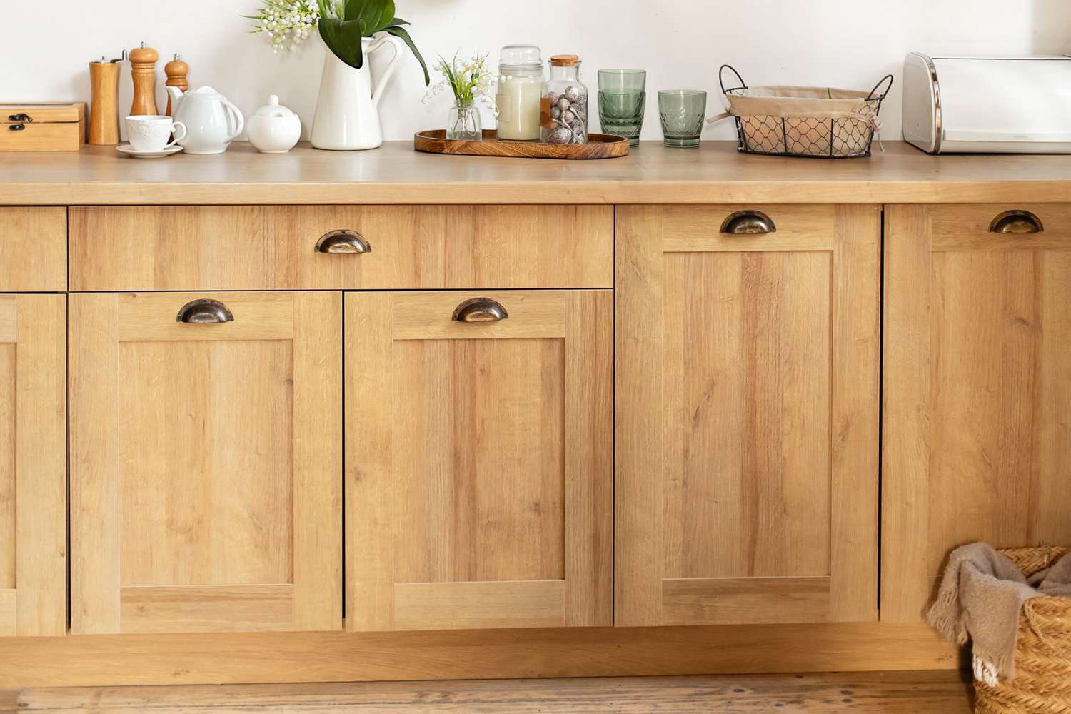 Wooden cuisine cabinet with clean dishes. Scandinavian style kitchen interior. Organization of storage in kitchen.