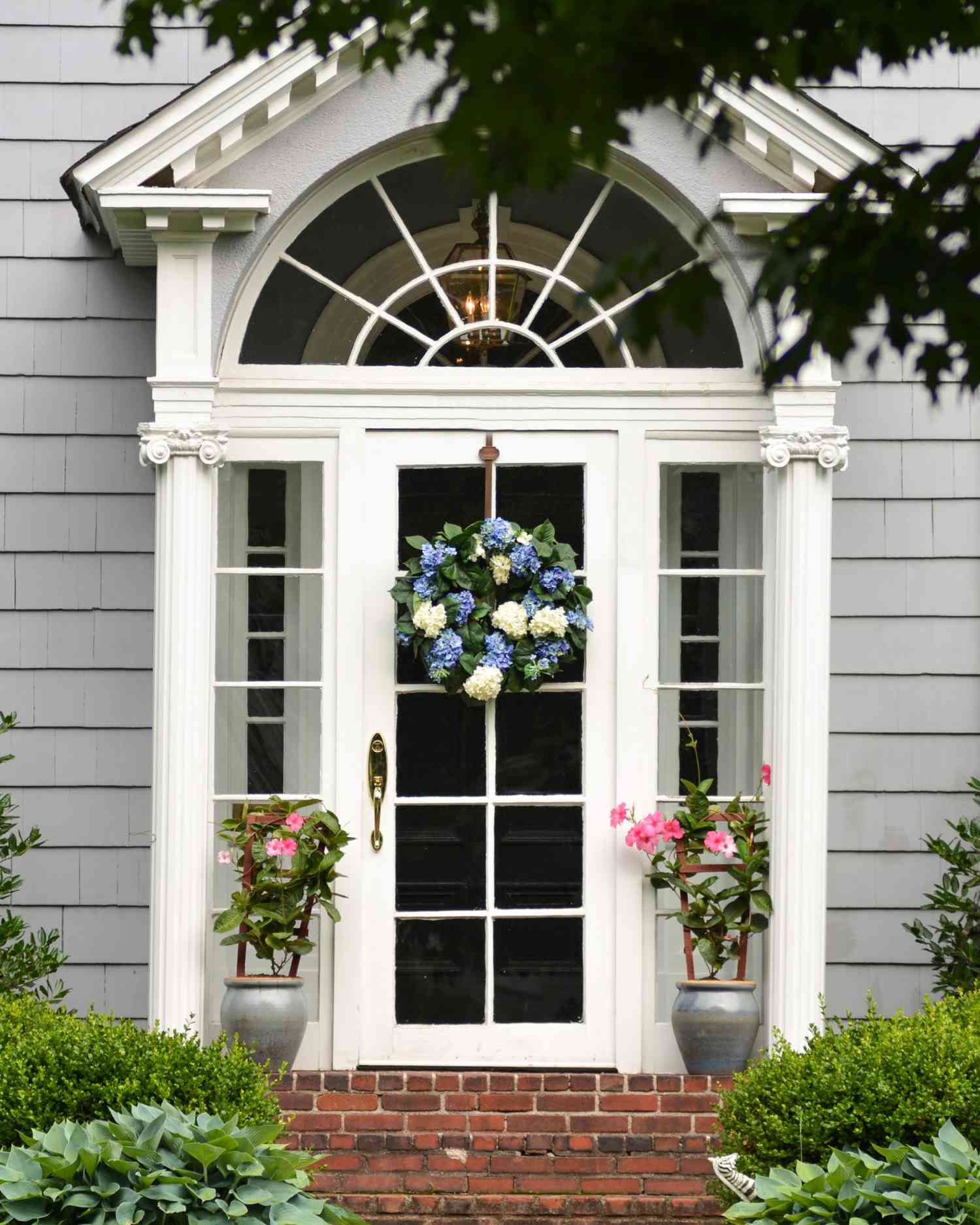 White front door with flowers on each side