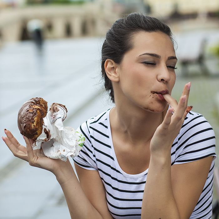 woman-eating-chocolate-donut.jpg