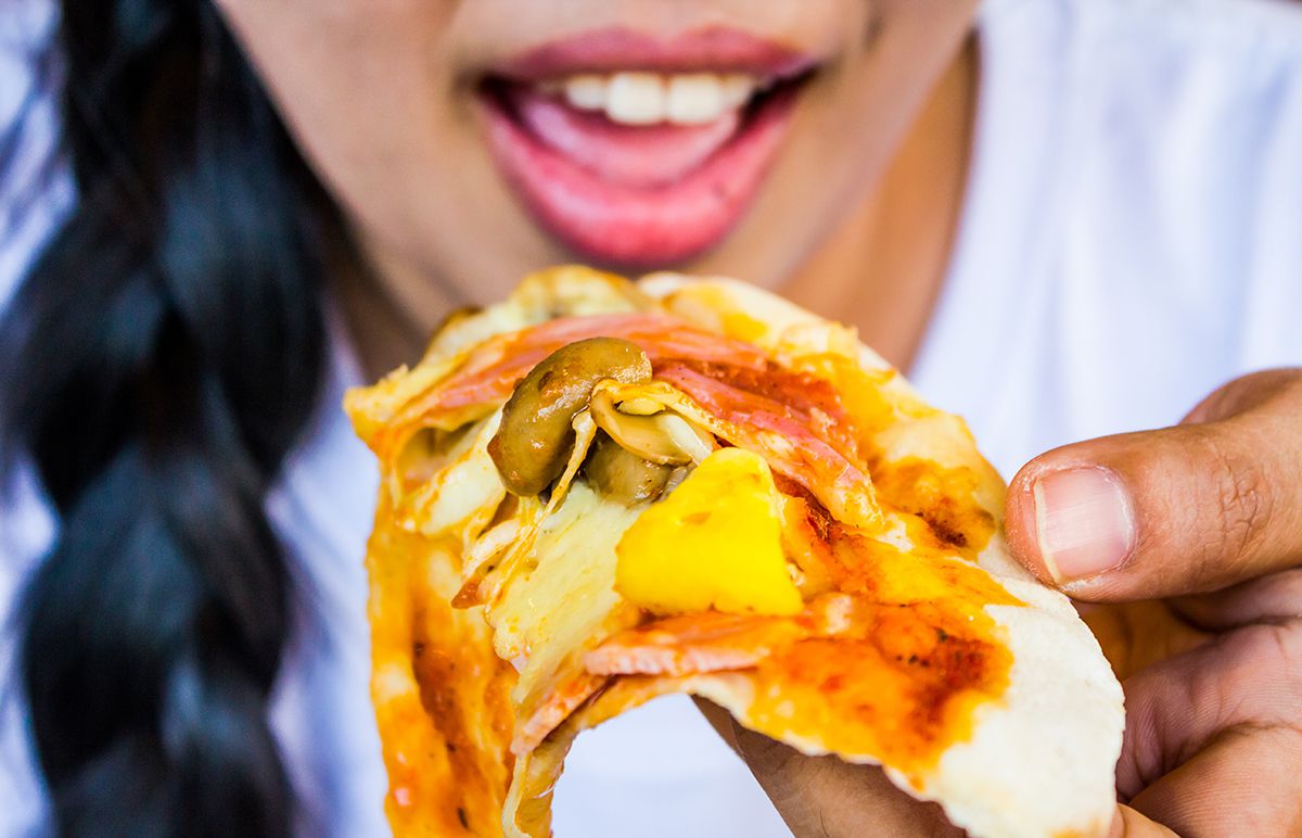 1200-woman-eating-pizza.jpg