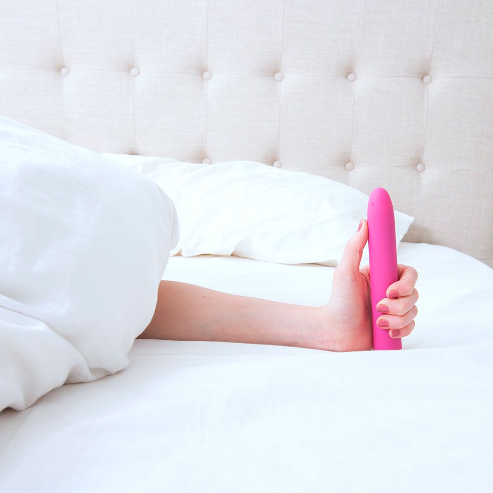 woman in bed using one of the best vibrators for women