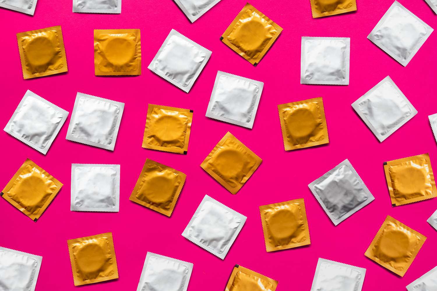 condoms on a bright pink background as concept for positive std diagnosis