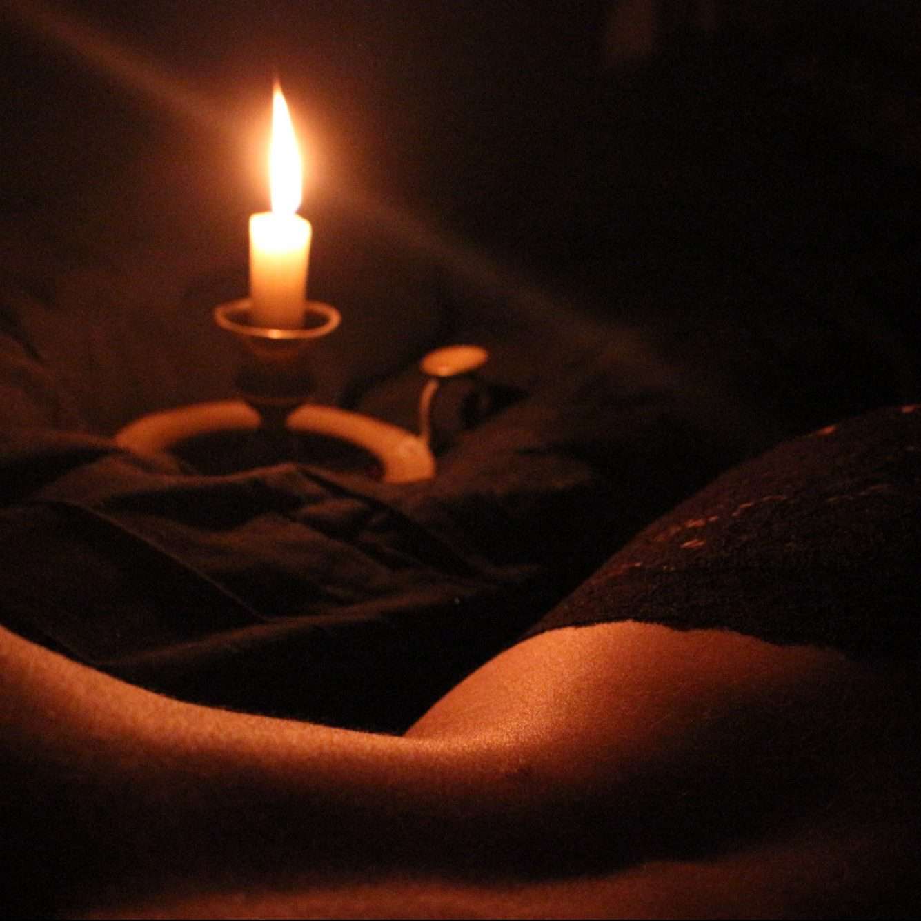 woman lying with sexy candle