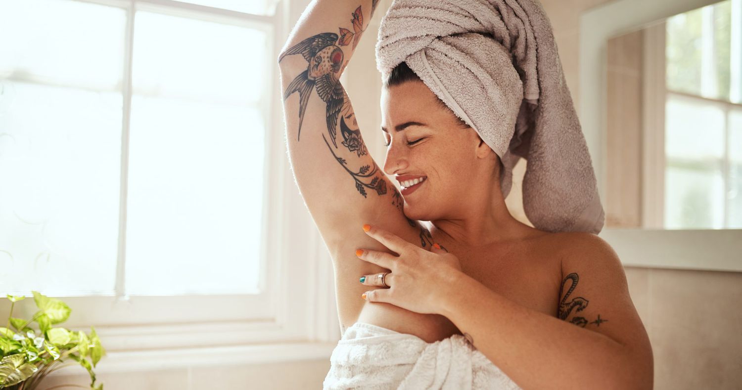 Woman_In_Towel_Smiling_Down_At_Her_Armpit