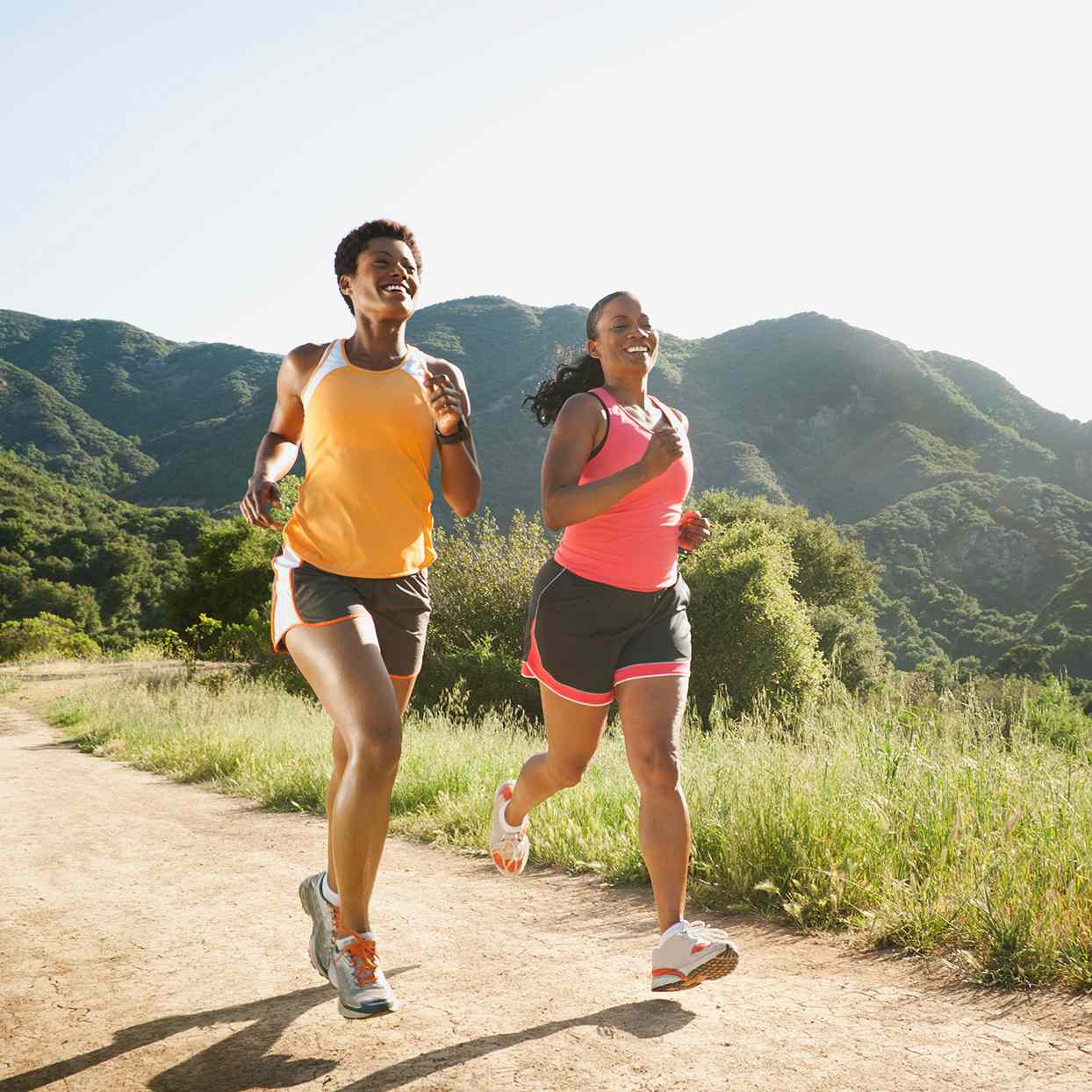 two women running on outdoor trail