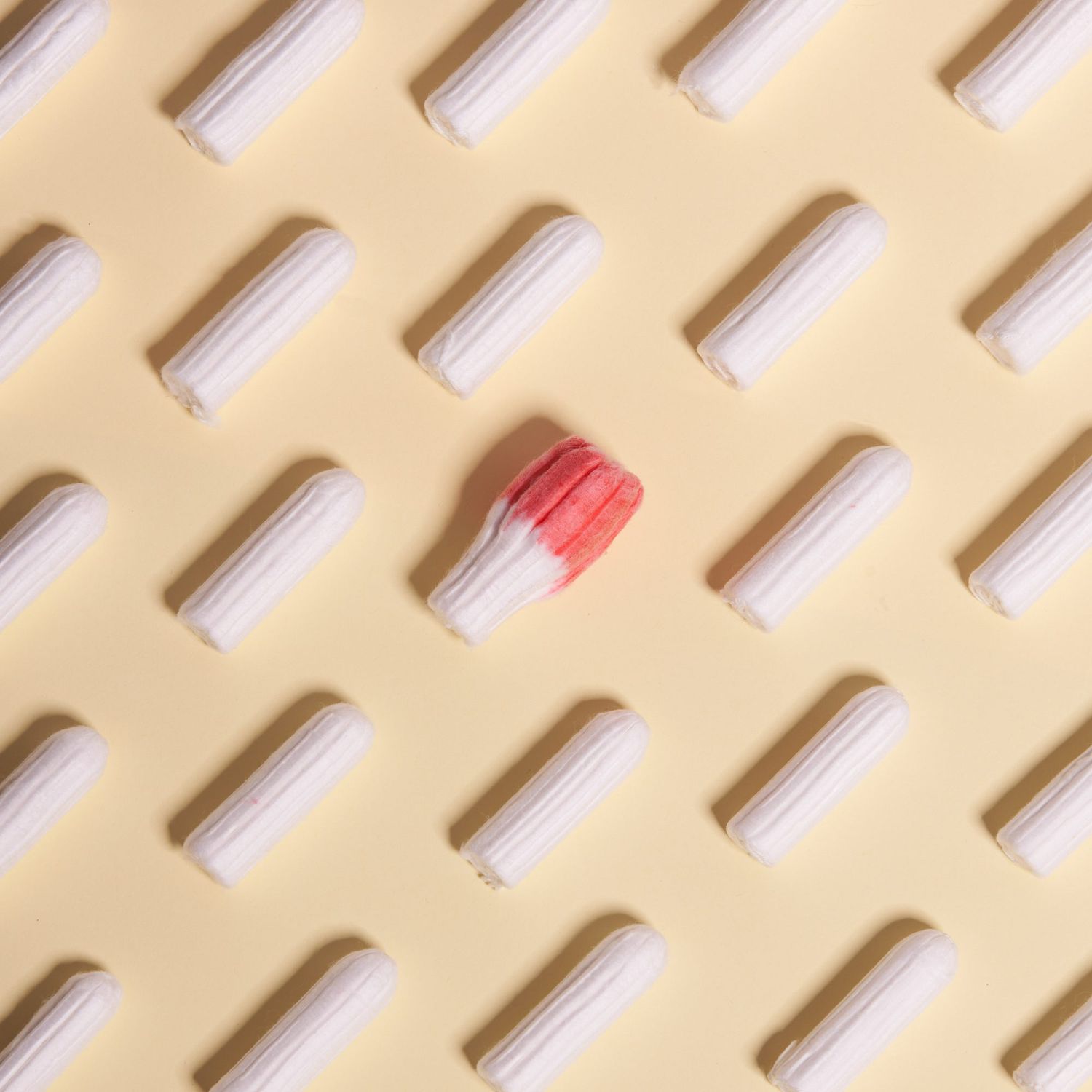 Directly Above Shot Of Tampons Against Beige Background as concept for menstrual cycle