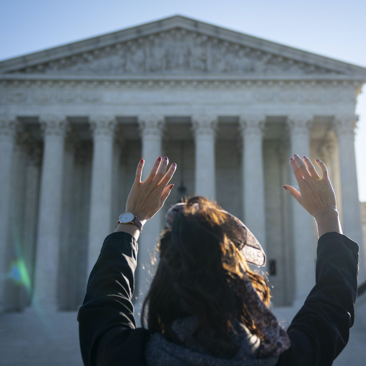 A woman with the pro-life organization Bound4Life raises her hands in prayer outside of the U.S. Supreme Court on October 5, 2020 in Washington, DC. With 8 justices currently on the bench, the Supreme Court begins a new term on Monday. With 8 justices currently on the bench, the Supreme Court begins a new term on Monday