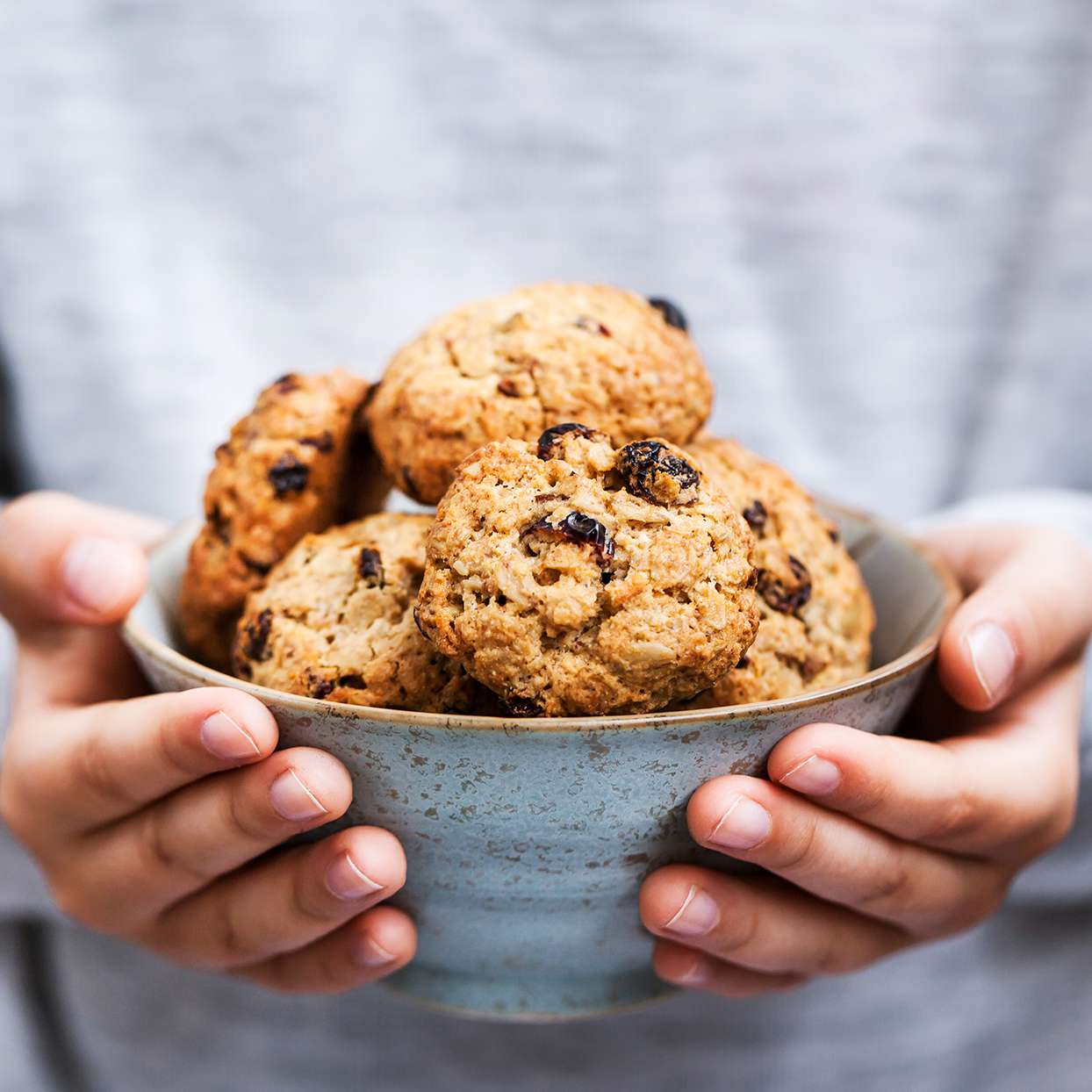 A woman holding a bowl of breakfast cookies