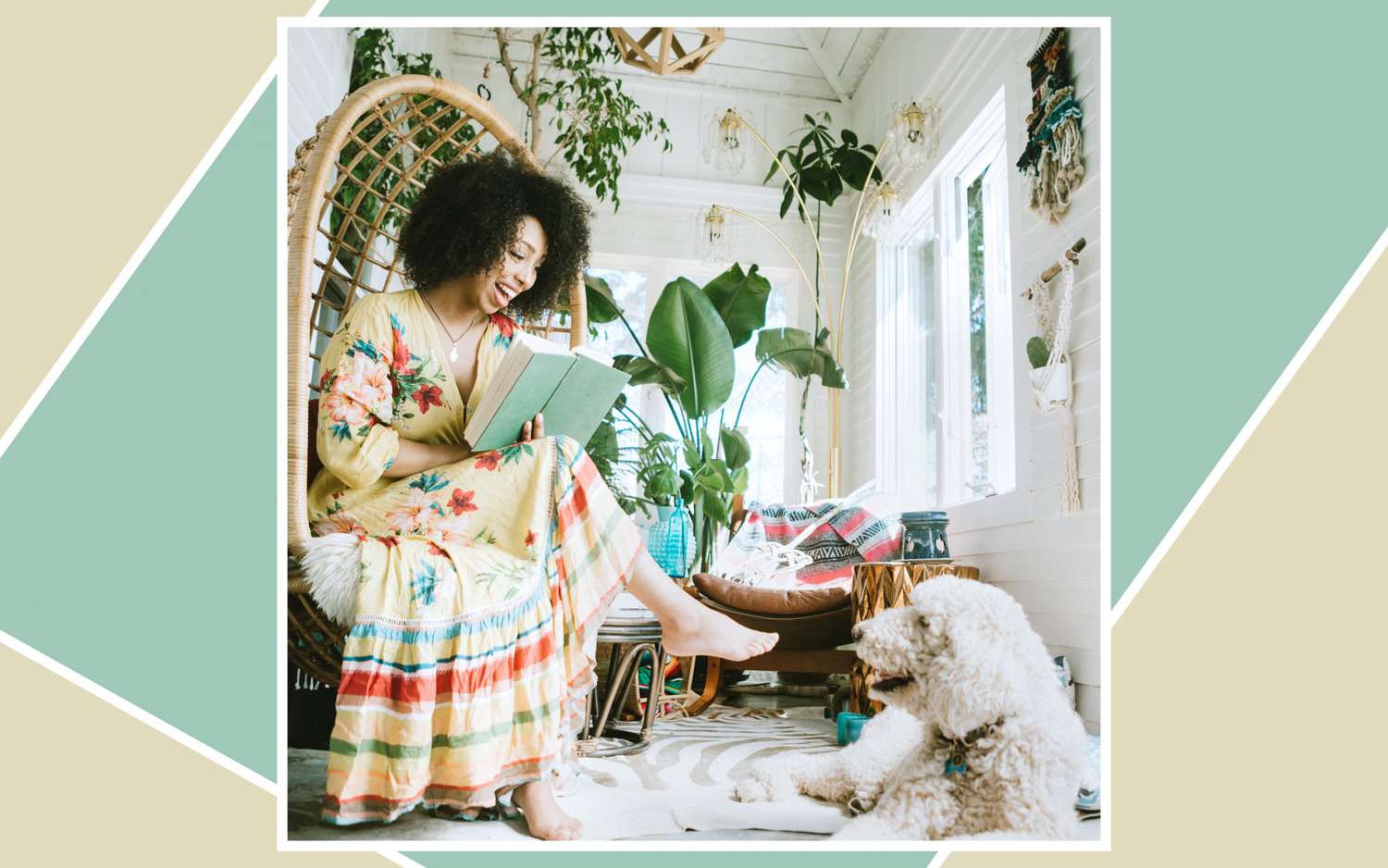 Woman sitting in her living room, reading a book with her dog