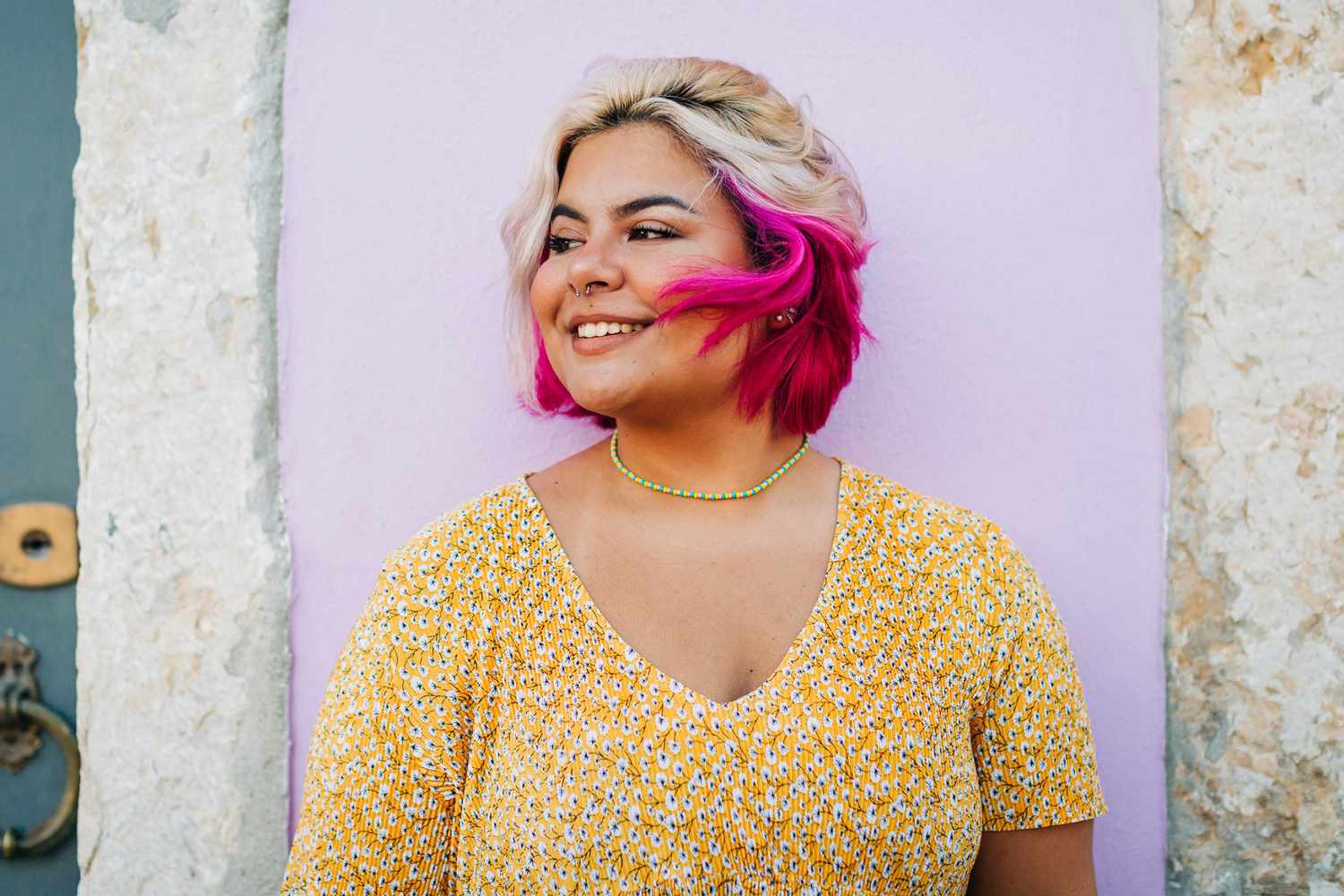 A woman with dyed hair smiling