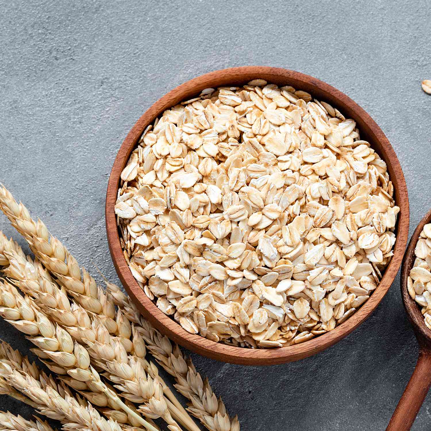 Rolled oats or oat flakes in wooden bowl
