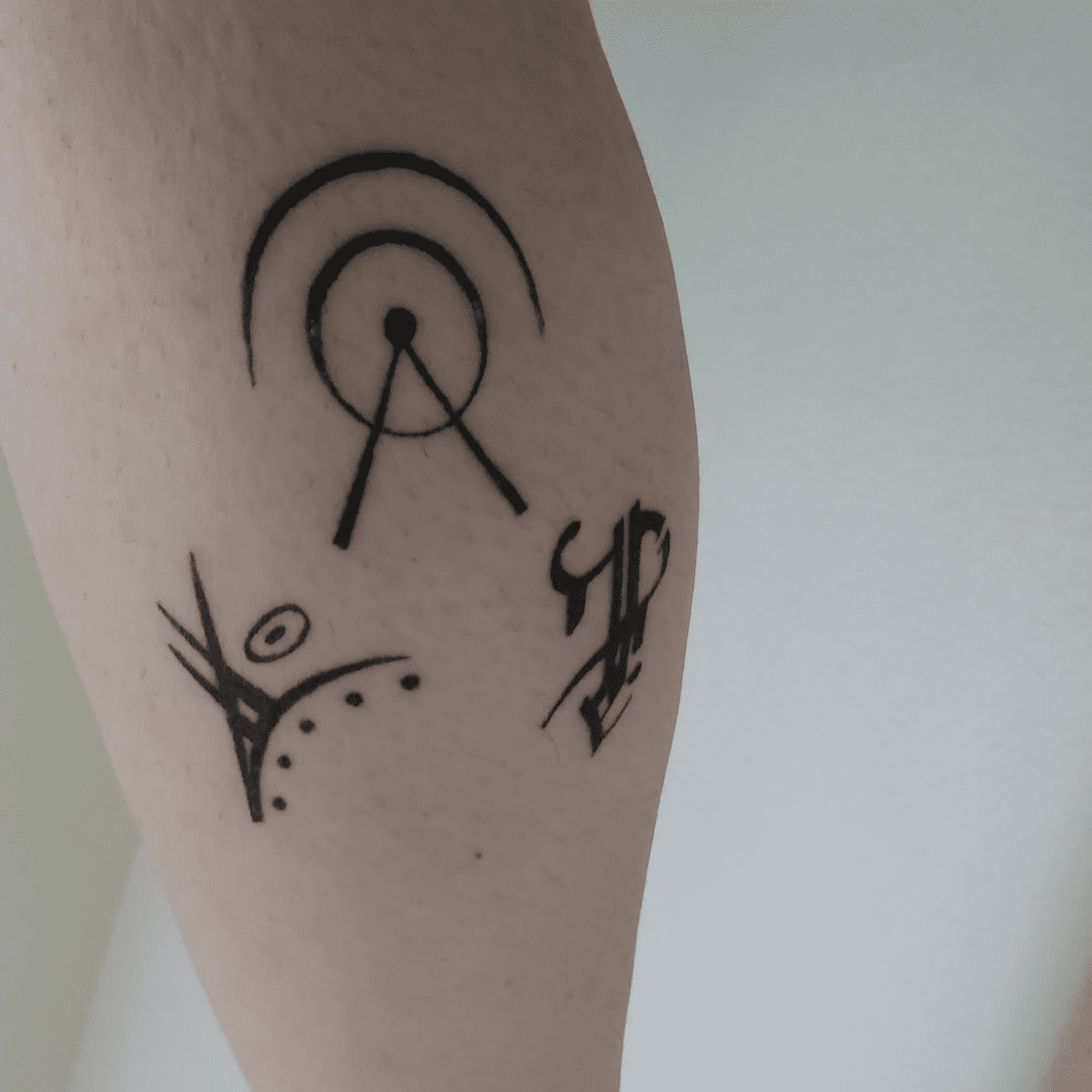 set of sigils tattoo on back of leg