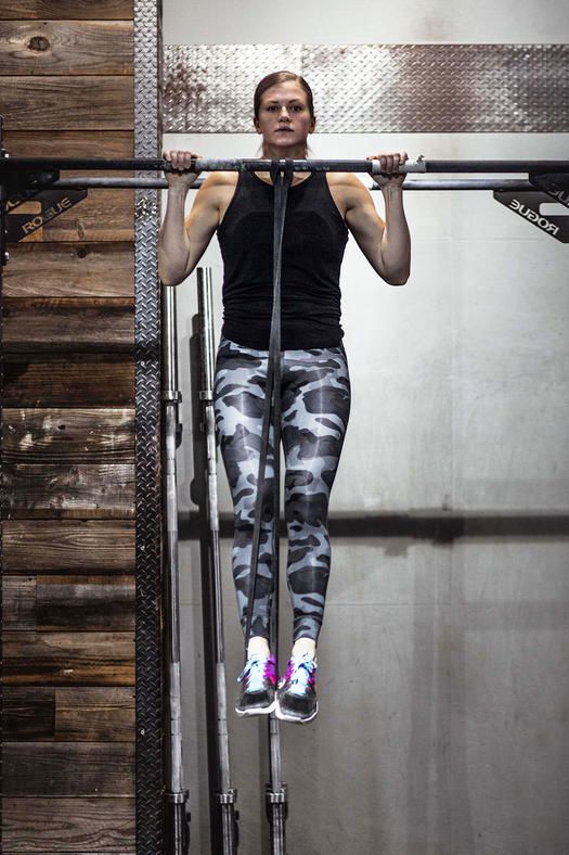 woman doing banded pull-up