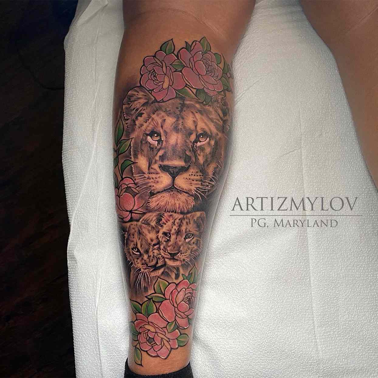 closeup of leg with lion tattoo