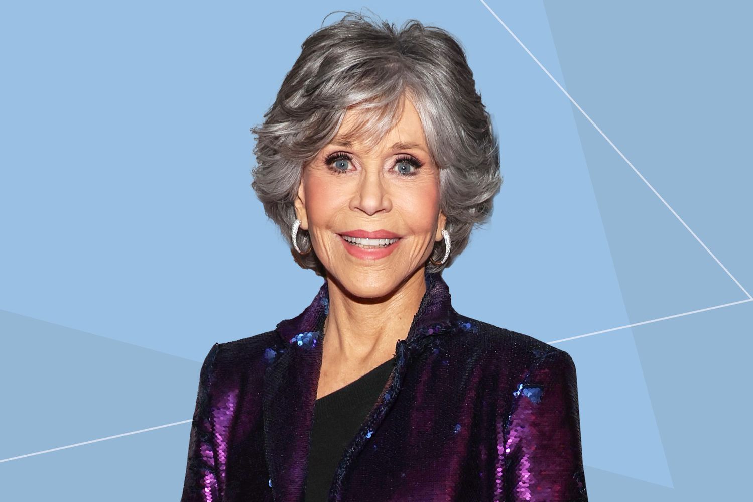 Jane Fonda wearing a purple suit against a blue background
