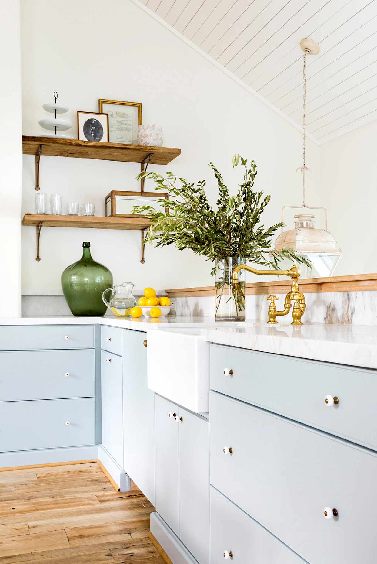 Kitchen with light blue cabinets and white counters