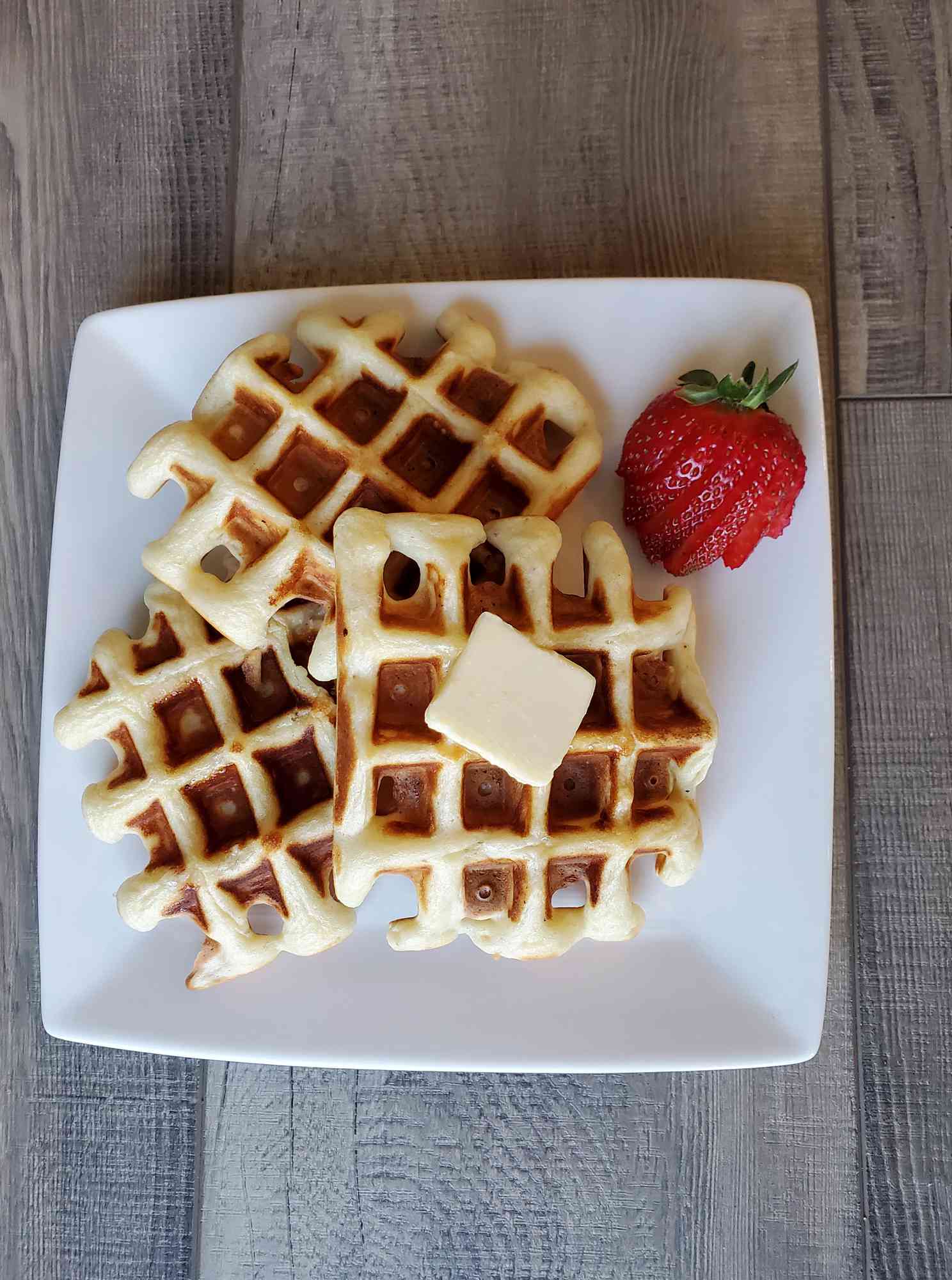 plate of overnight waffles with butter