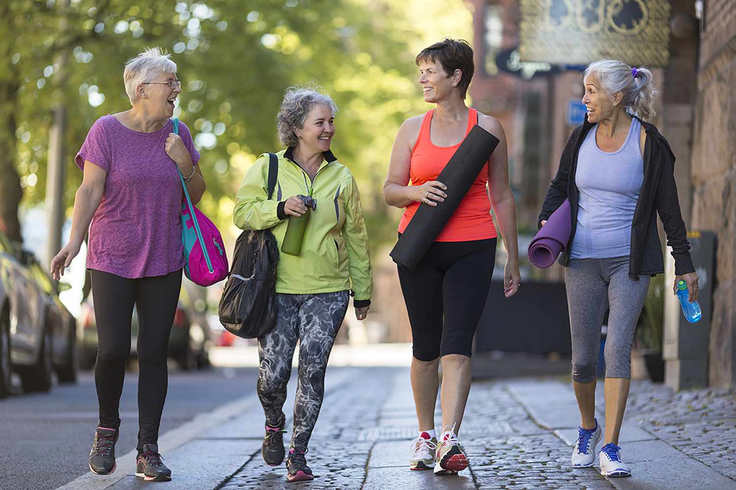 Group of middle age women walking together in fitness clothing