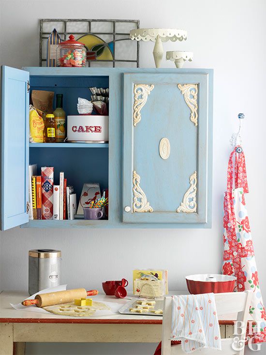 Blue cabinet door with cream wooden cutouts attached
