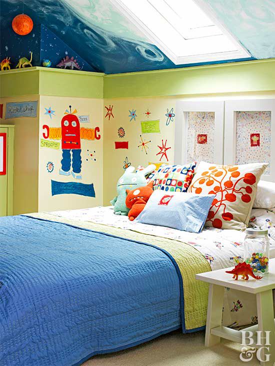 Kid&iquest;s room painted in robot theme with blue bedspread