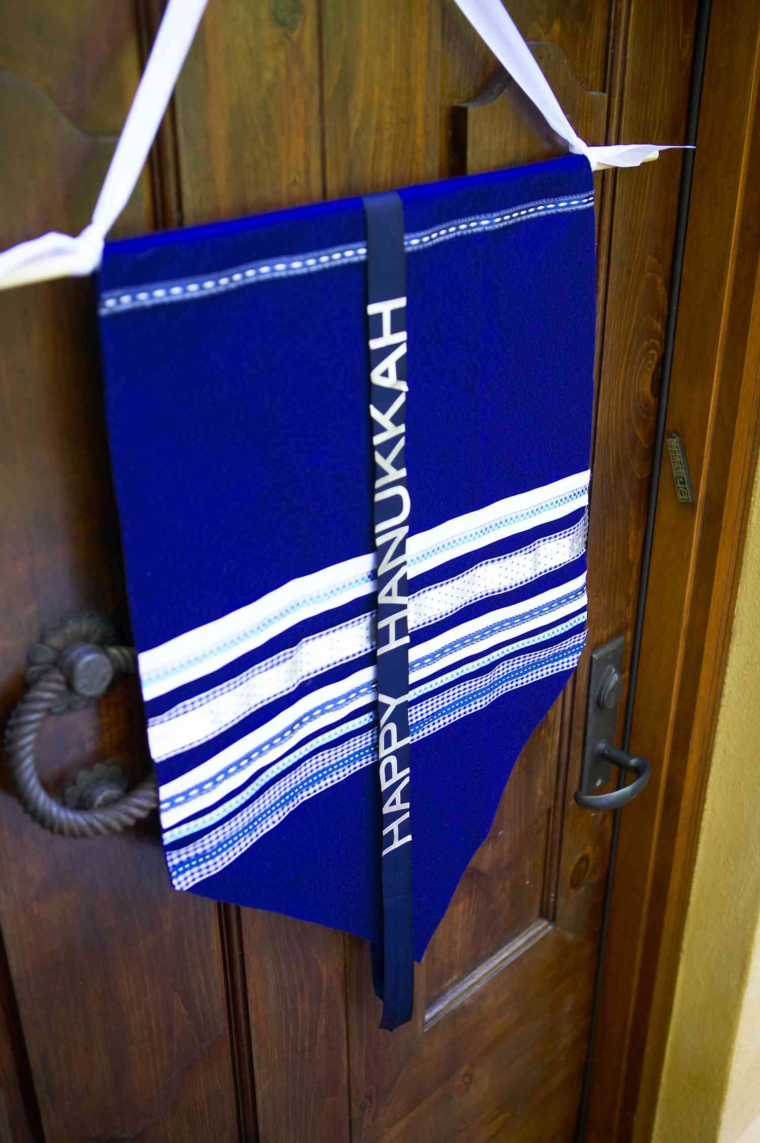 blue handing Hanukkah banner on front door