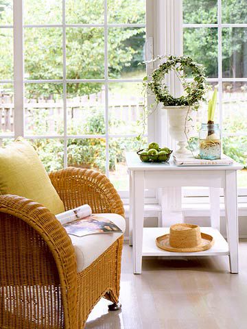 CottStyleSp05_Wicker chair in front of large windows overlooking garden