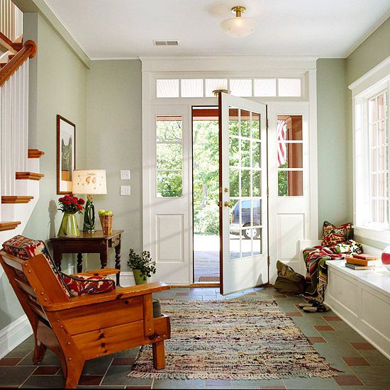 Green Entryway With White Window Seat and Wooden Armchair