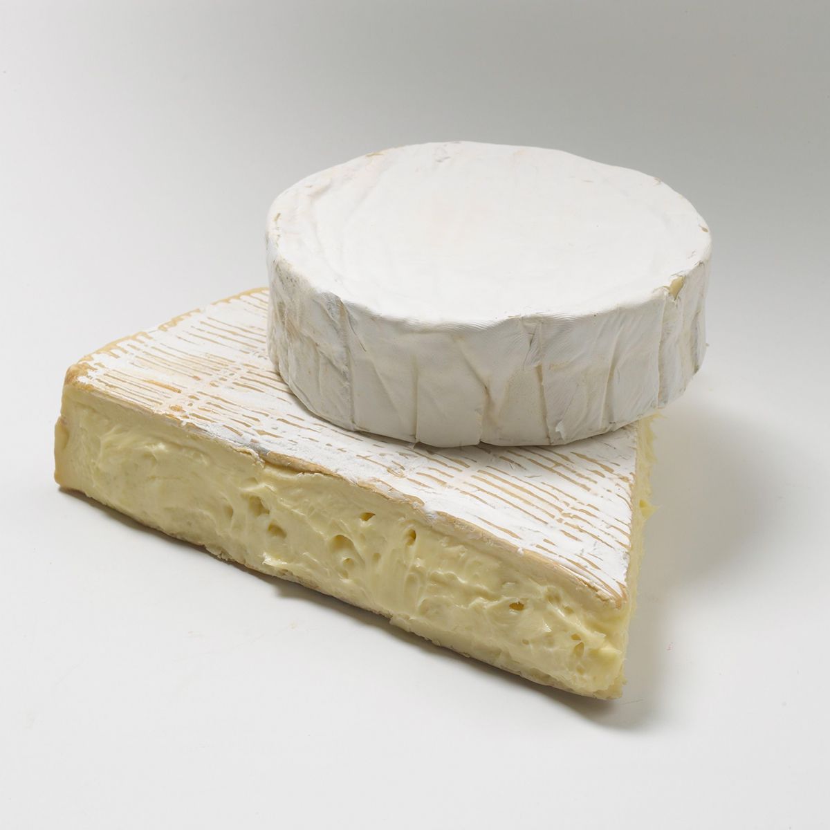 Brie and Camembert cheese stacked on each other