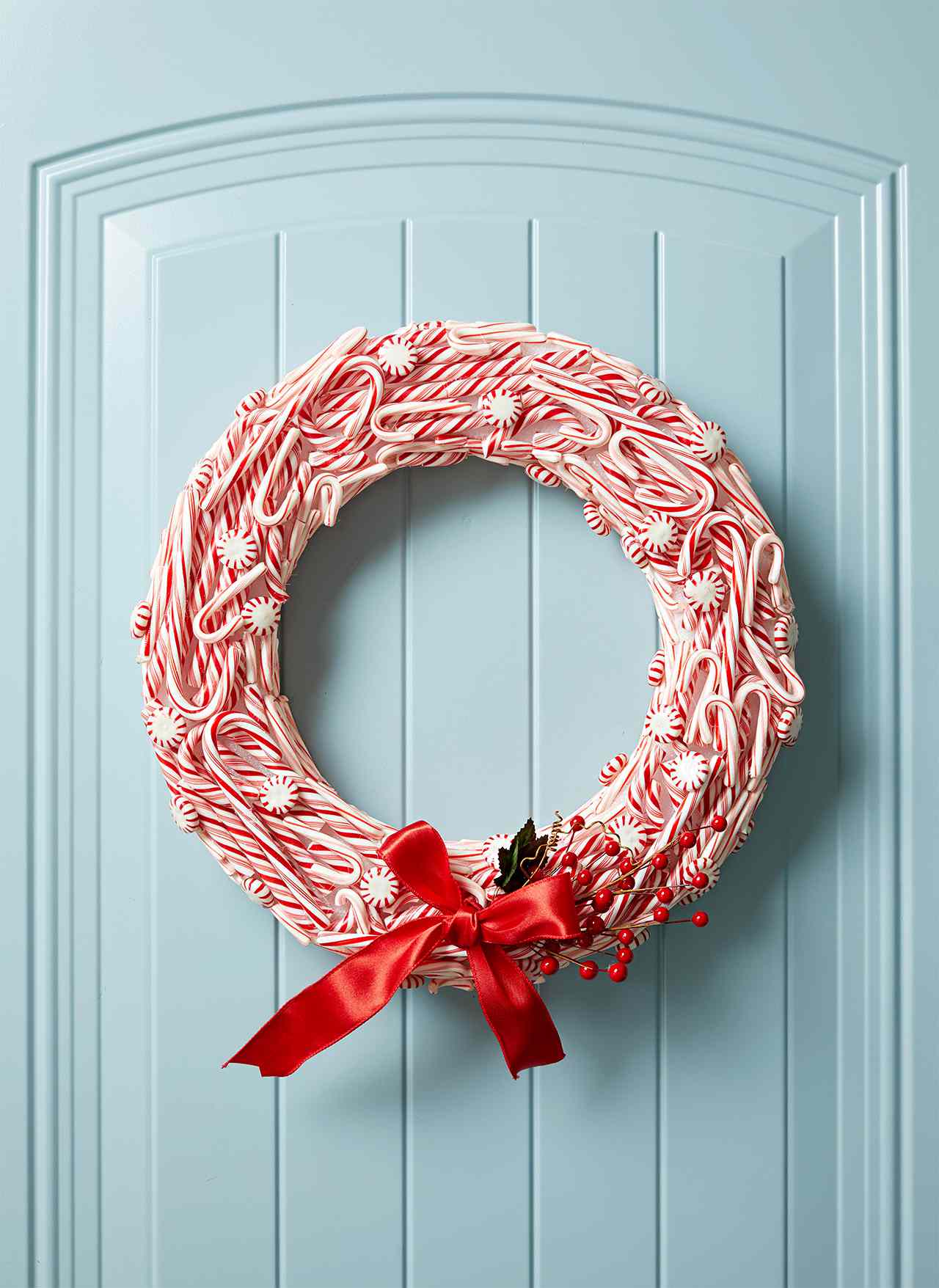 hanging red and white wreath with peppermint candies