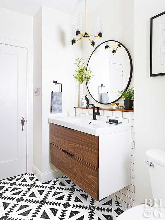 modern bathroom with round mirror and single sink cabinet