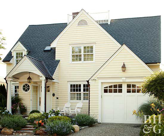 pale yellow exterior with landscaping