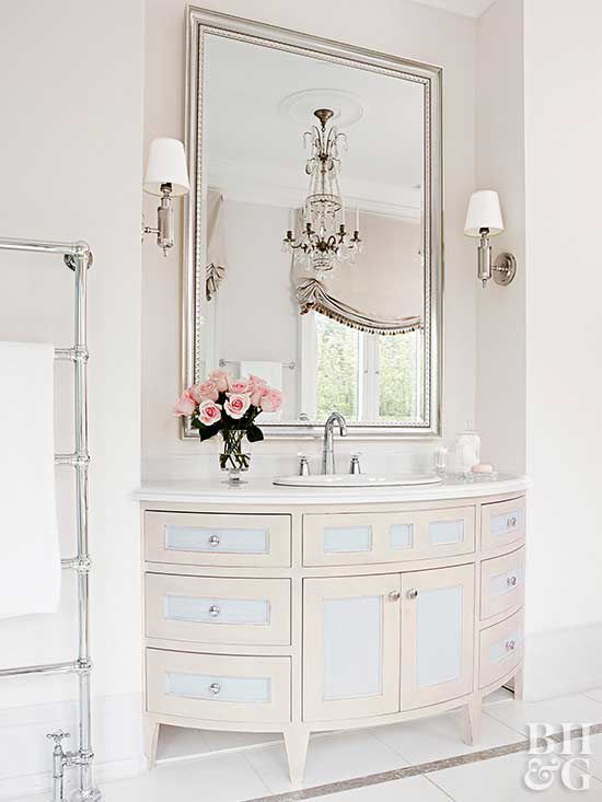 large white bathroom vanity with one sink and large chrome mirror above