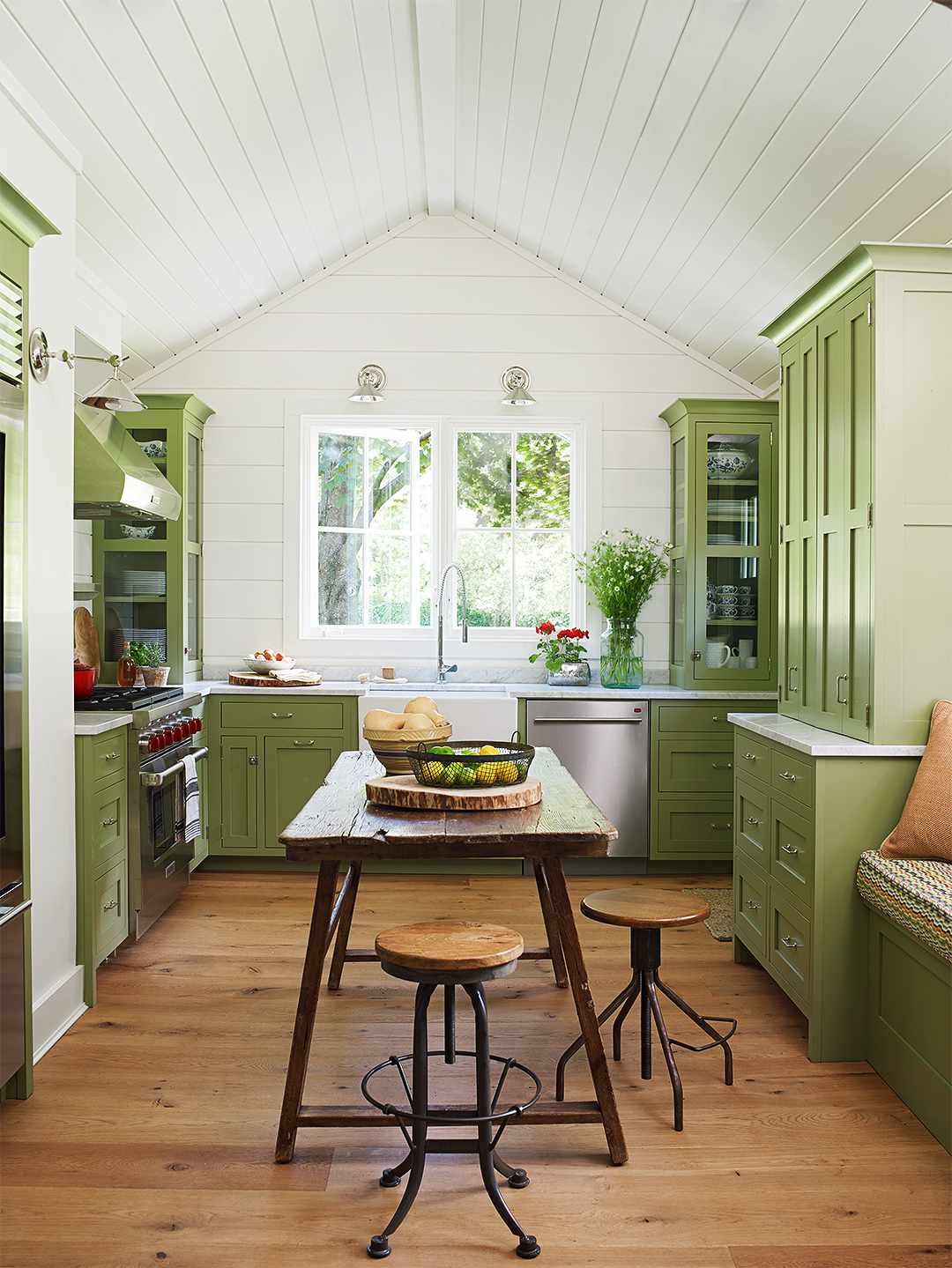 green wood kitchen with pitched shiplap ceiling table stools