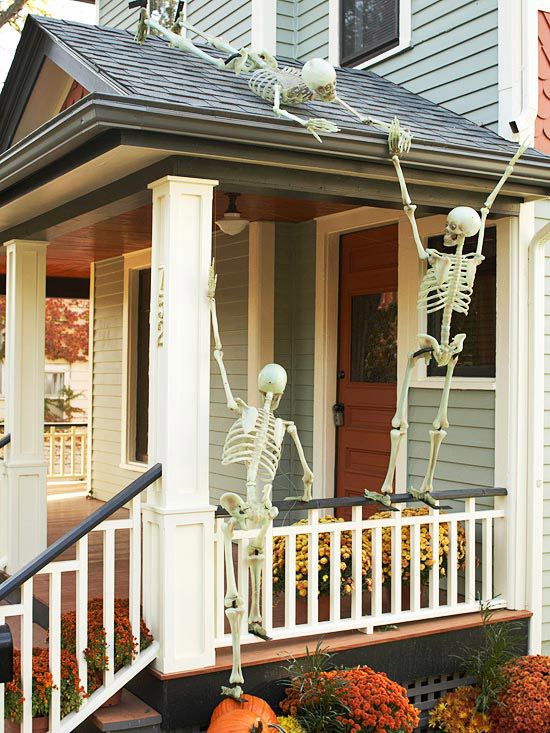 Halloween skeletons climbing front porch.