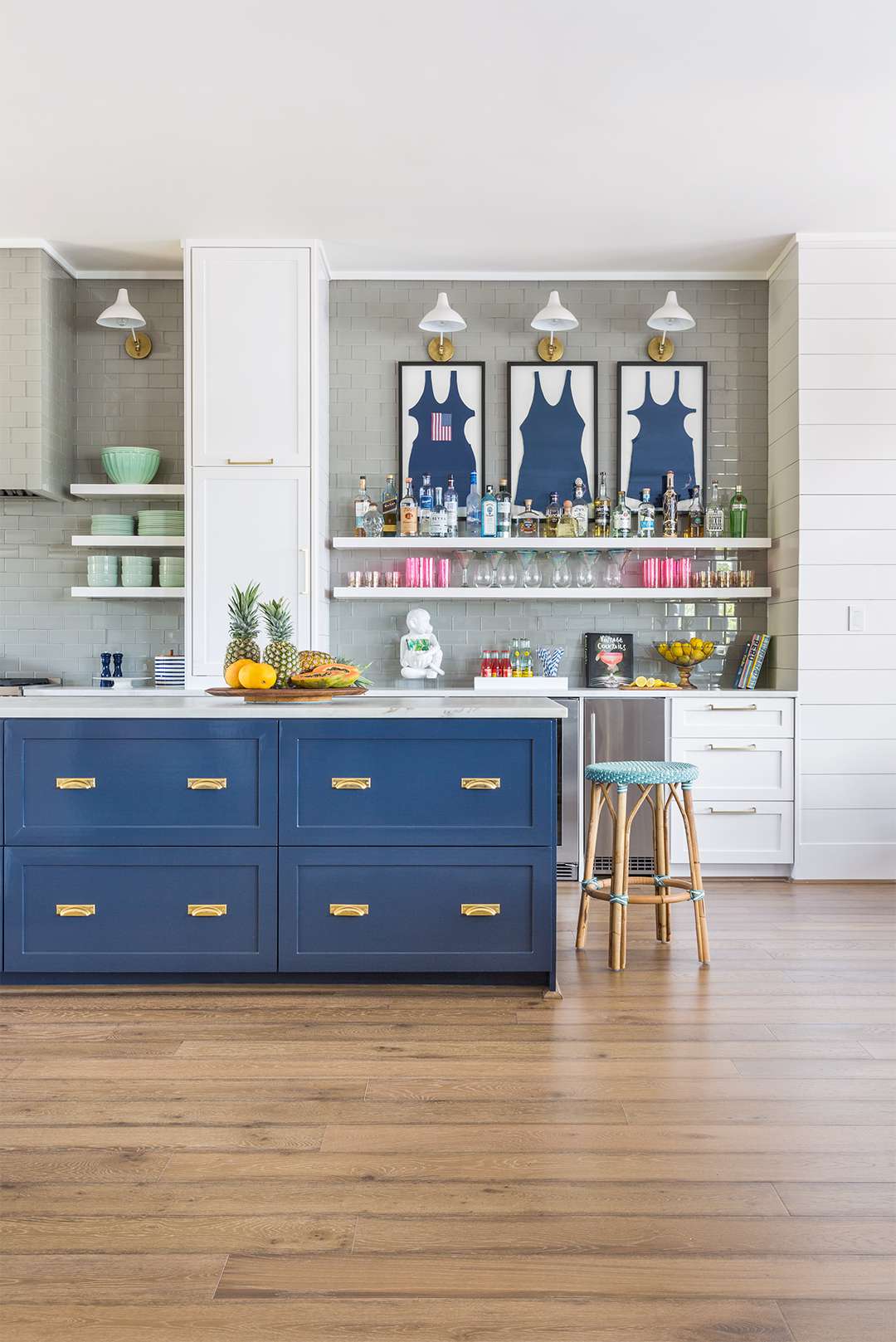 nautical kitchen with blue island and vintage swimsuits framed