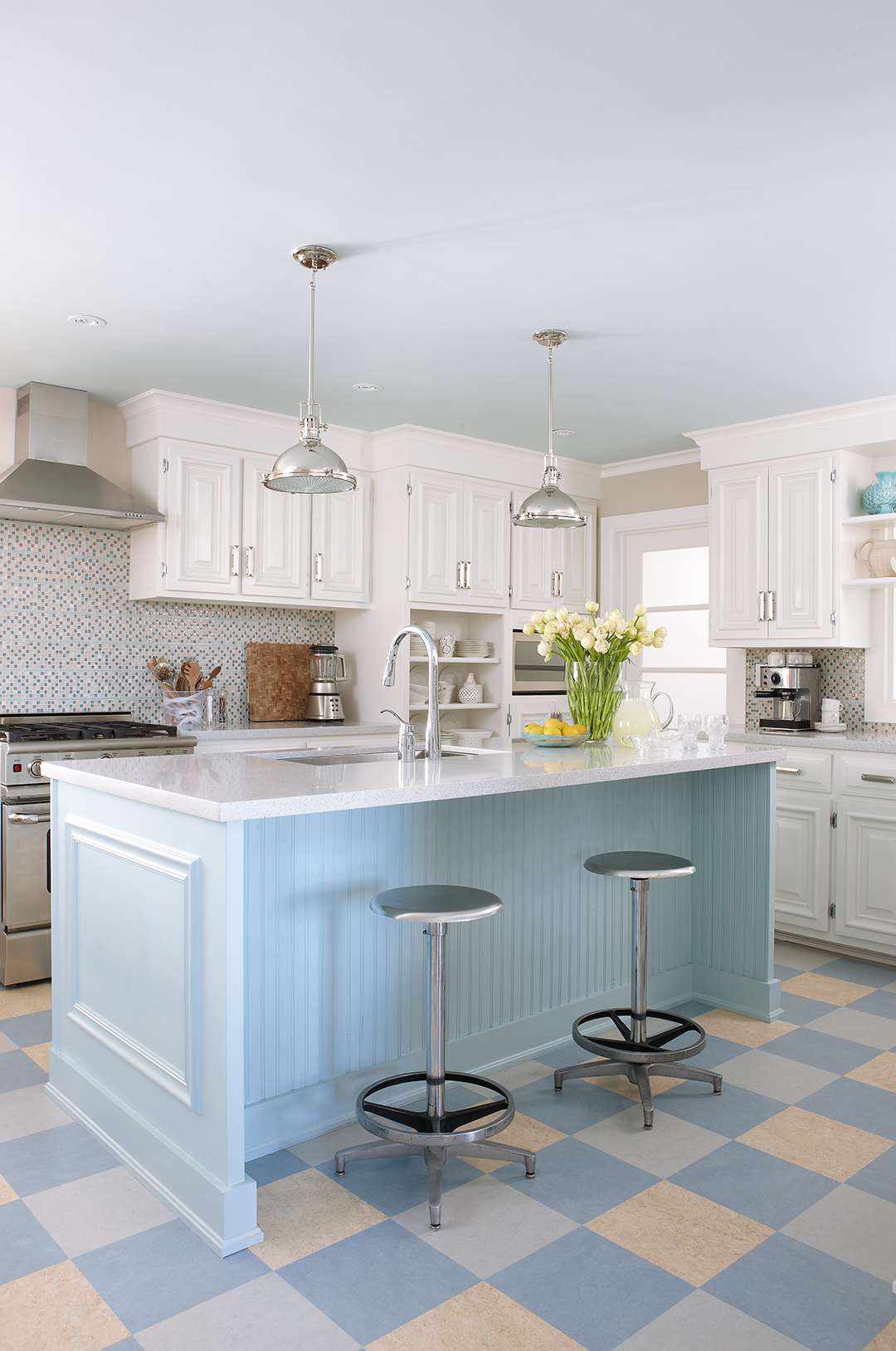 kitchen with blue island and white cabinets