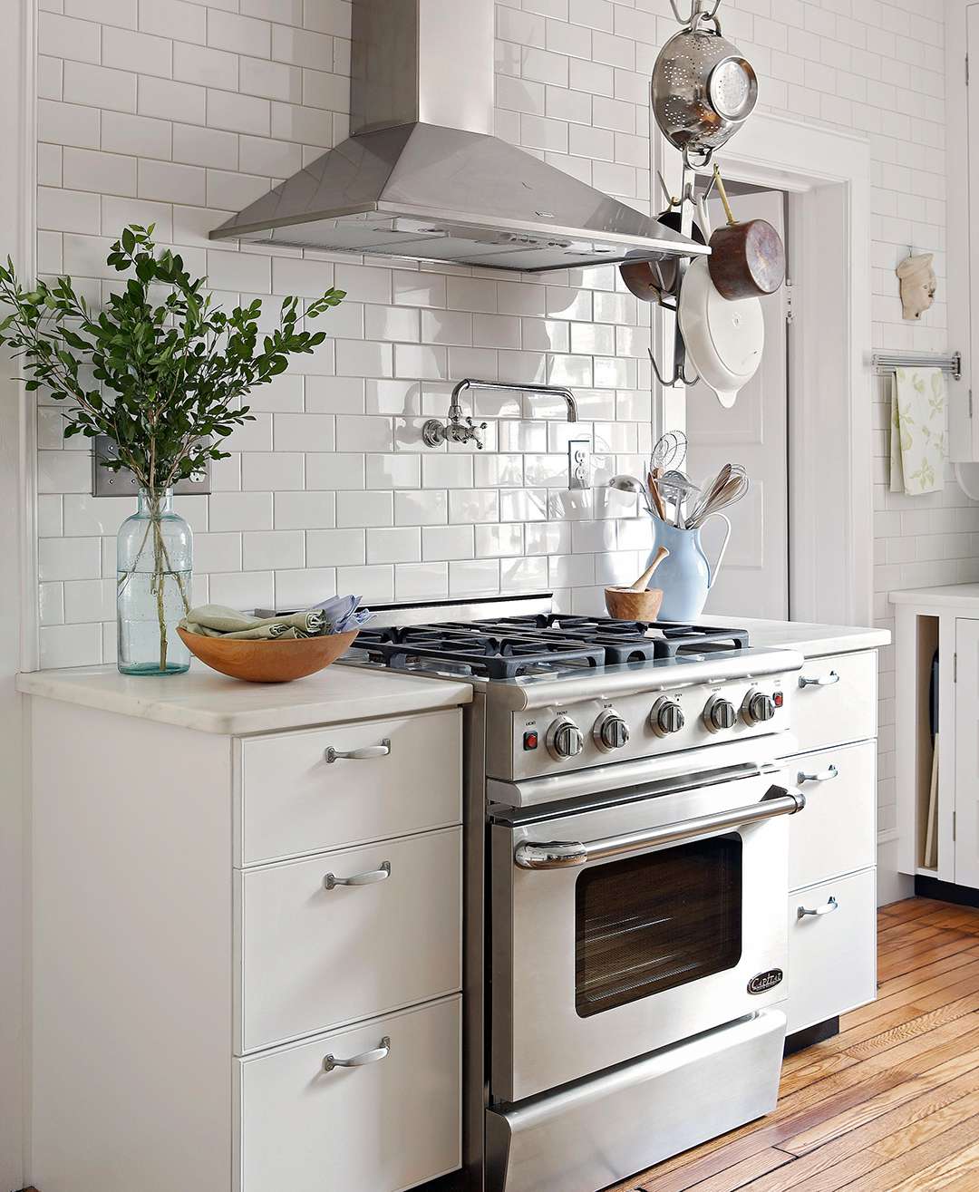 white kitchen stove oven range with hanging pots