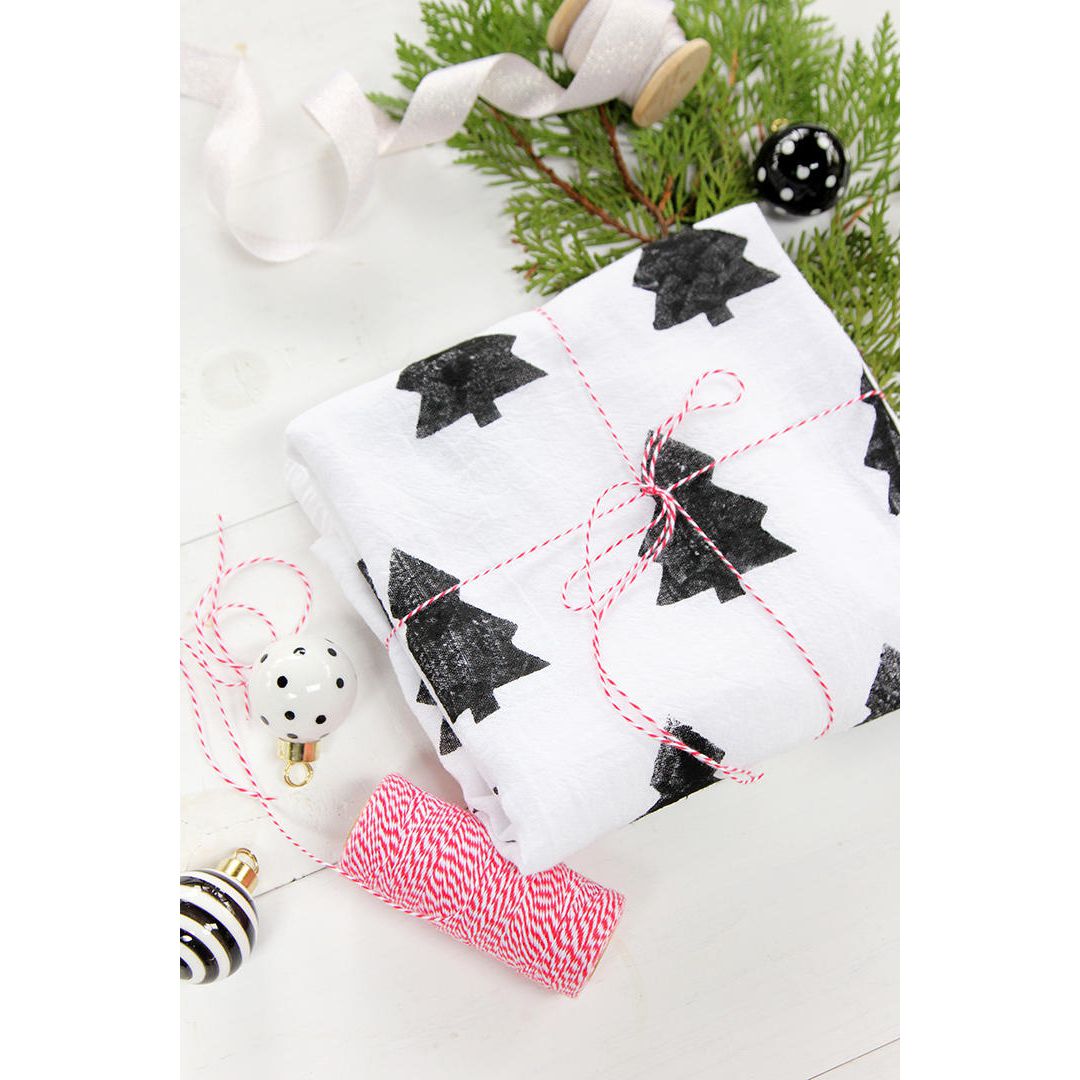 white towel with black christmas trees tied with red and white string